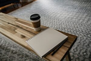 朝の机の上のノートとコーヒーの様子